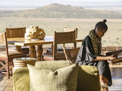 singita_sasakwa_lodge_guest_on_verandah